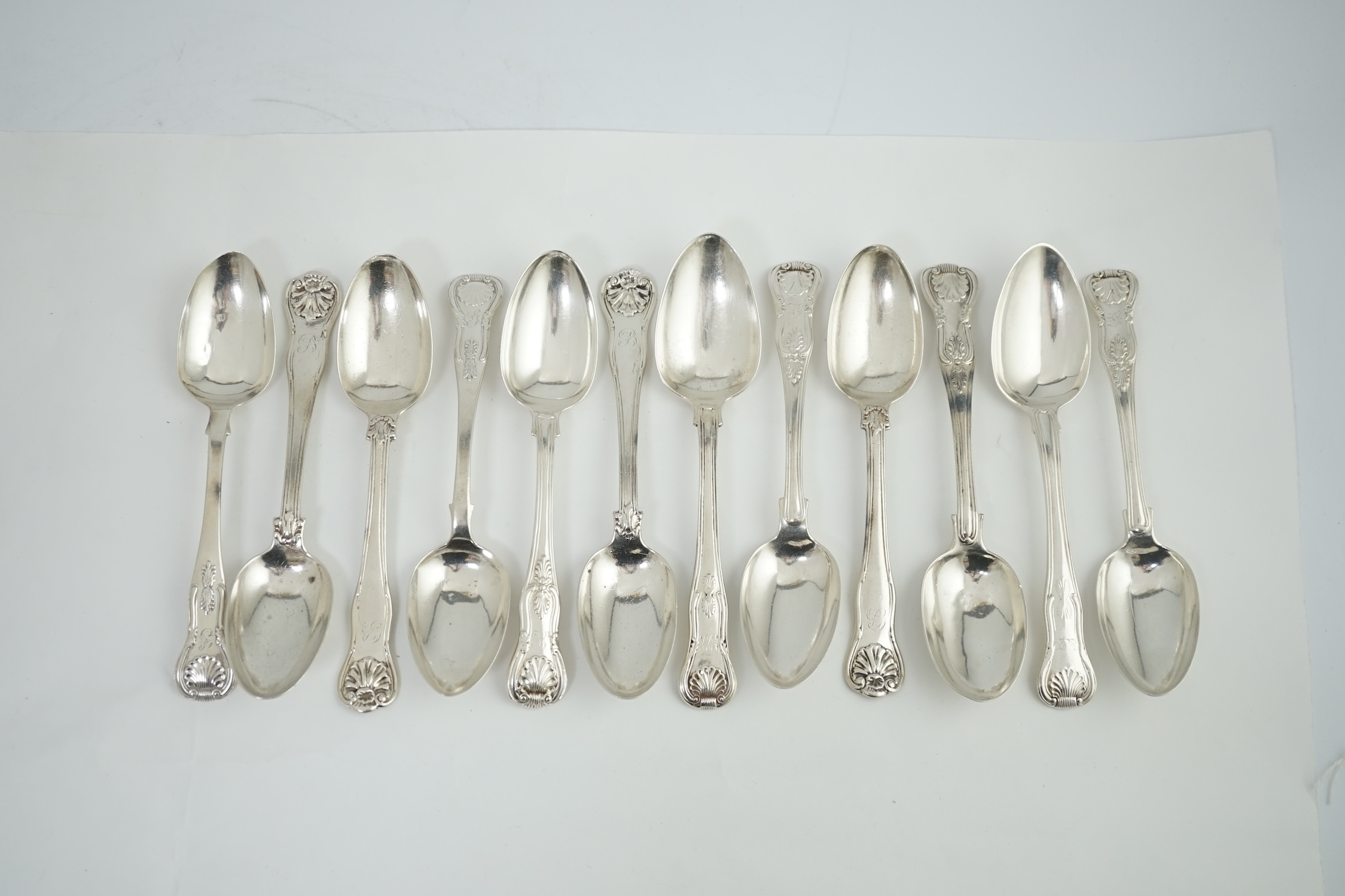 A harlequin set of twelve Georgian and Victorian silver Kings pattern dessert spoons, various dates and makers